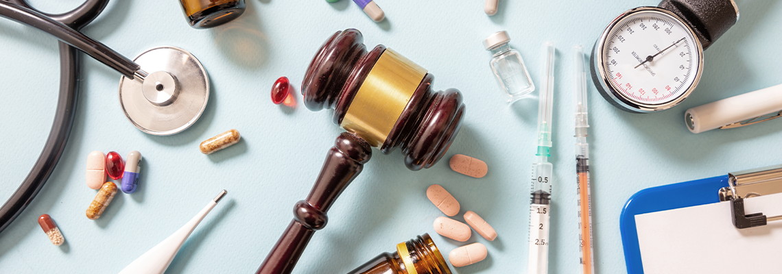 Judge gavel, medical stethoscope and medicine