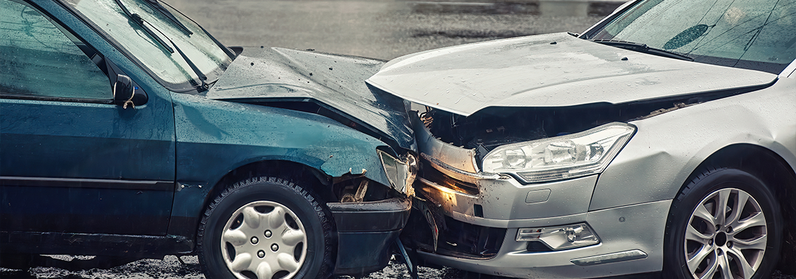 Car accident on wet road during rain, head on collision side view