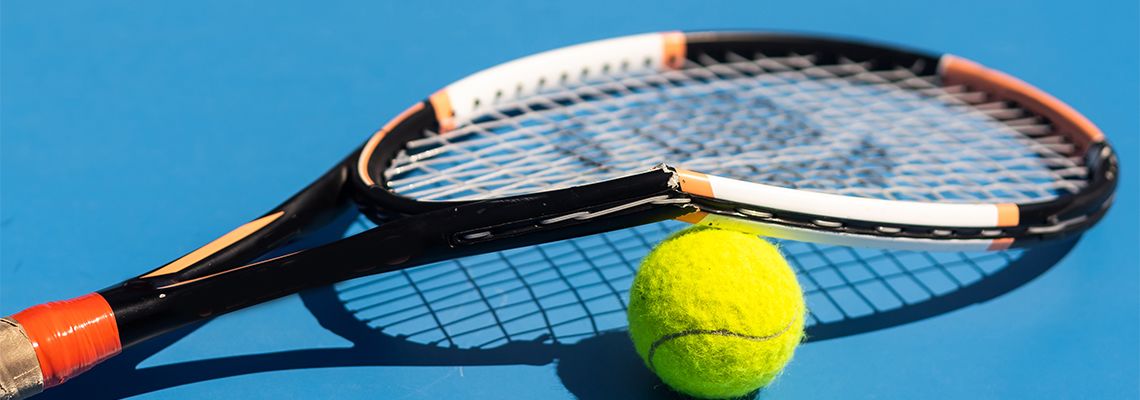 Broken tennis racket and ball