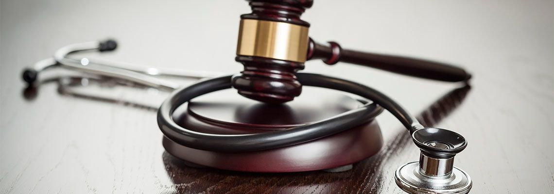Gavel and Stethoscope in table