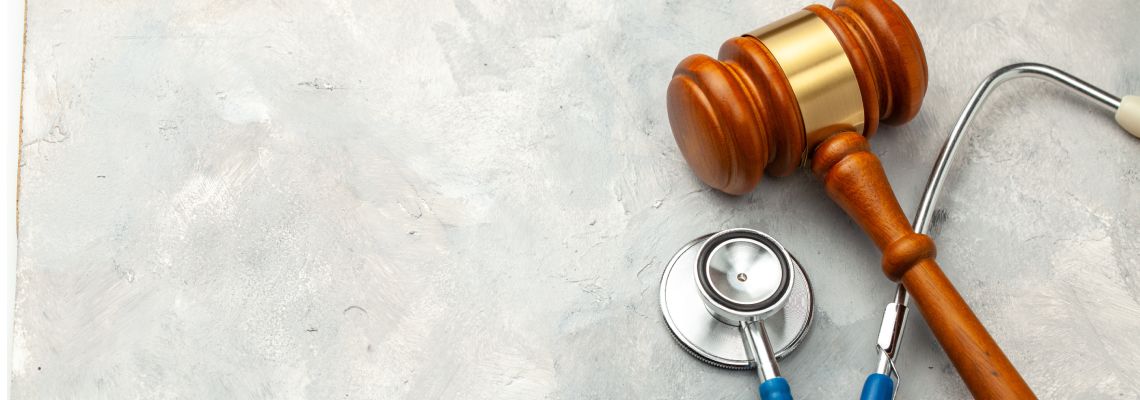 Gavel and stethoscope in table
