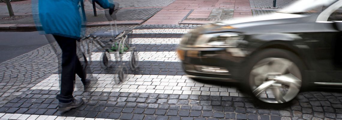 Car about to collide with pedestrian at road crossing