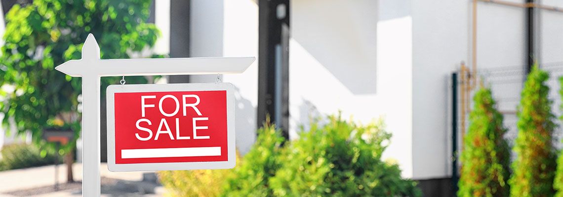 For sale sign near house outdoors