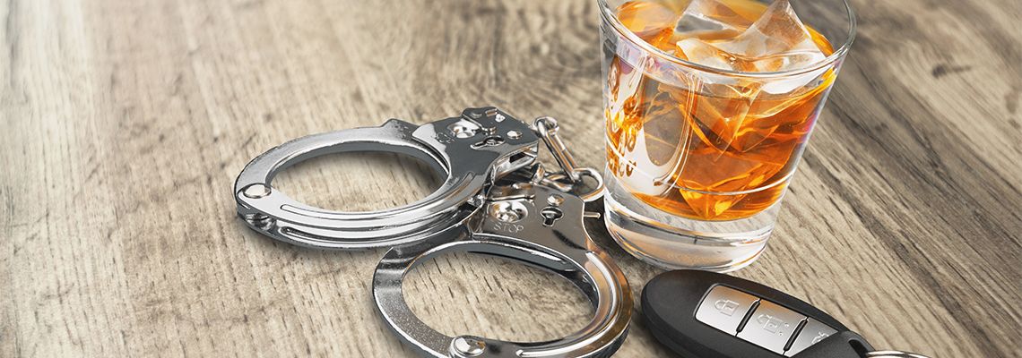 Car keys, Glass of Alcohol and Handcuffs