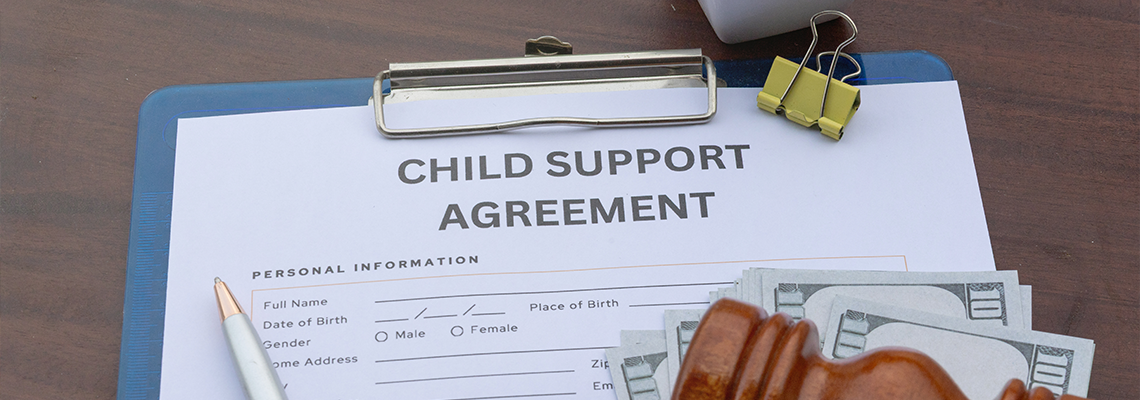 Child Support Payment and Legal Agreement Paper on Desk