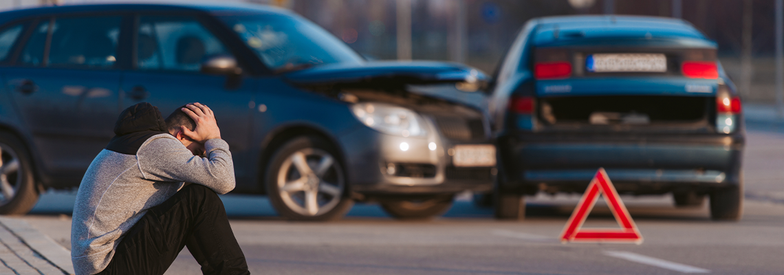 Sad man after car accident in road