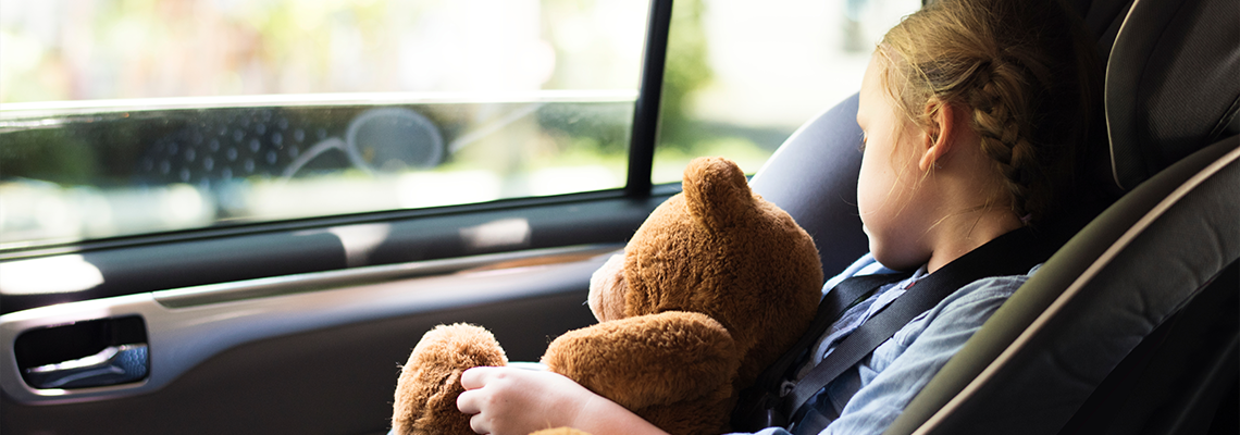A little girl sleeping in a car seat