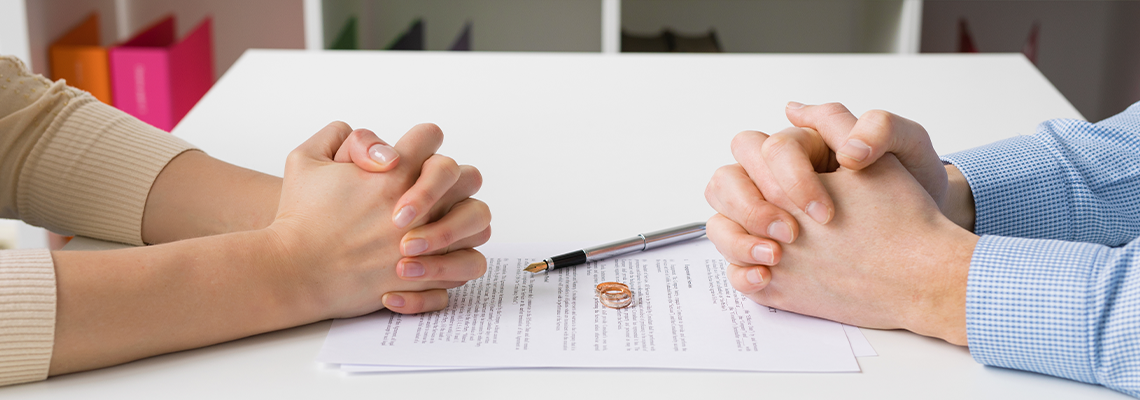 Couple going through divorce signing papers