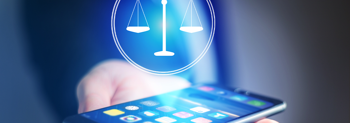 Businessman hand holding mobile phone with justice icon
