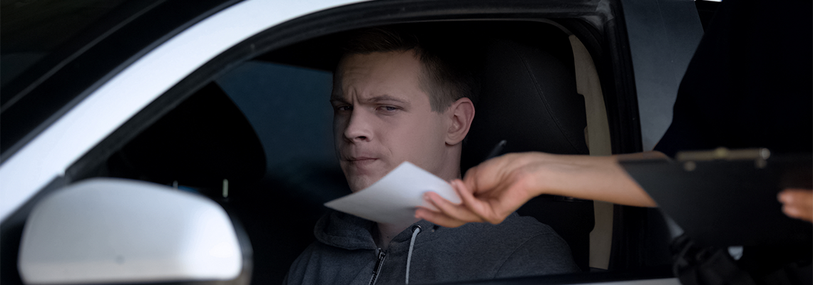 Police Woman Giving Fine Receipt to Driver on Road