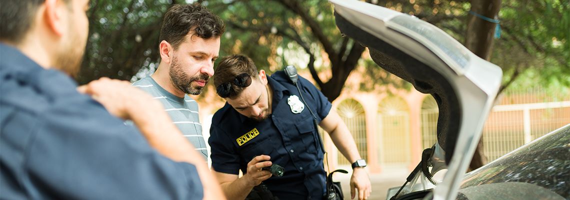 Police searching man's car trunk