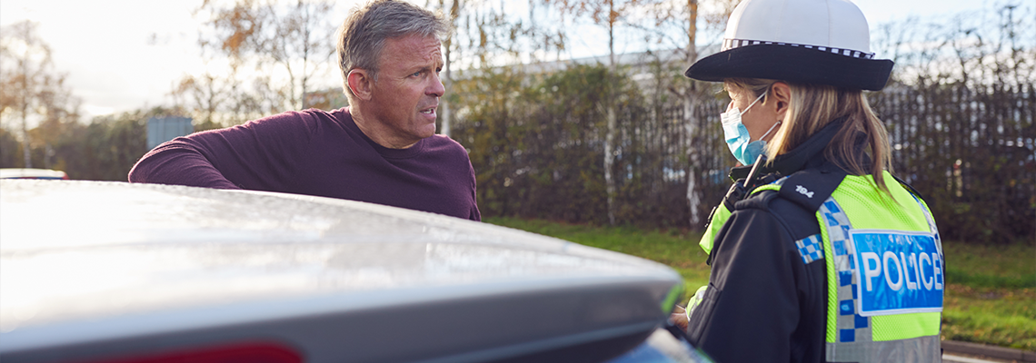 Male Driver Being Stopped By Female Traffic Police Officer