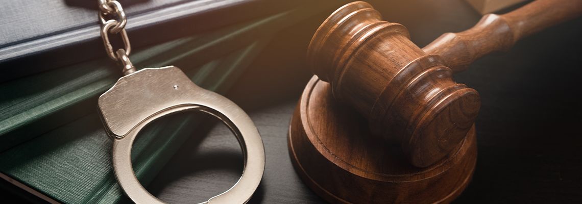 Handcuff and Gavel on Table