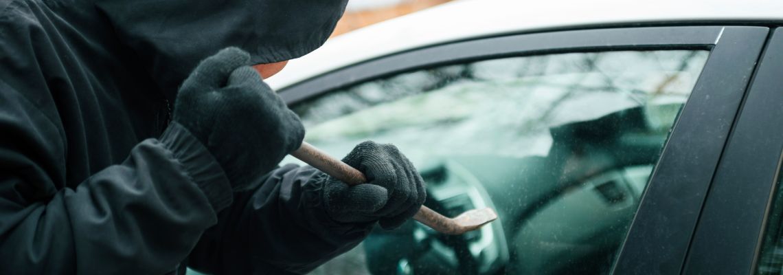 Car Thief breaking into a parked car