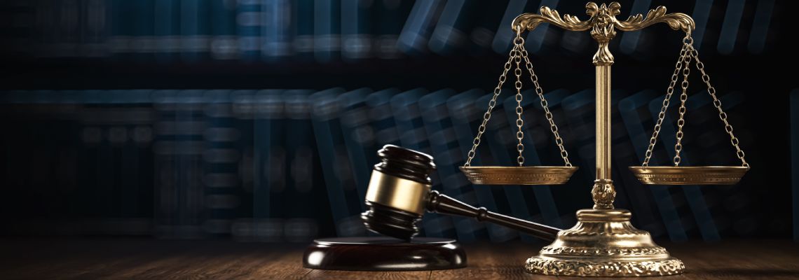 Gavel and Scale of Justice in table