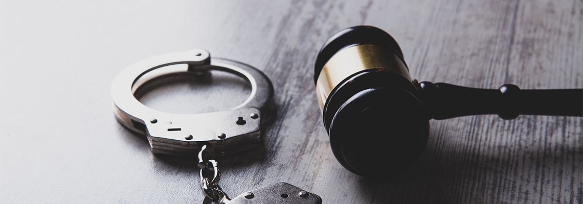 Gavel and handcuff on desk