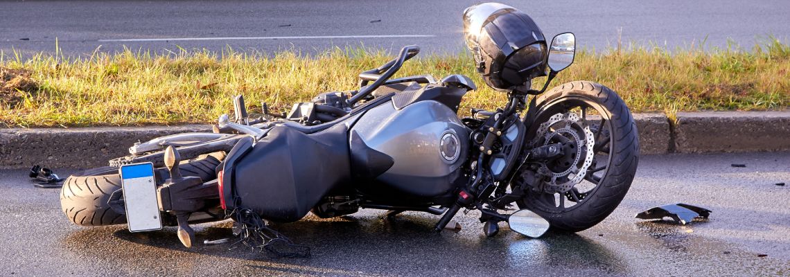 Damaged motorcycle on road after accident