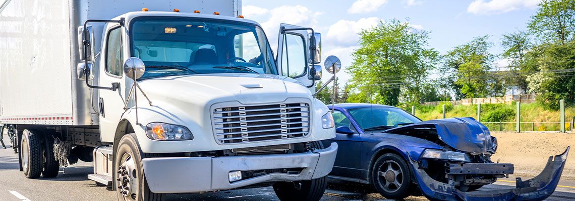 Road accident between car and delivery truck
