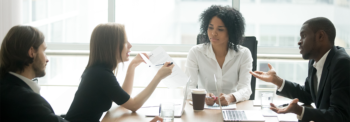 Diverse business partners arguing about bad contract at meeting in lawyers office