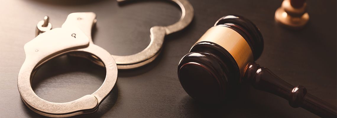 Gavel and Handcuffs on table