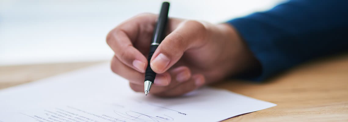 Signing a piece of paper