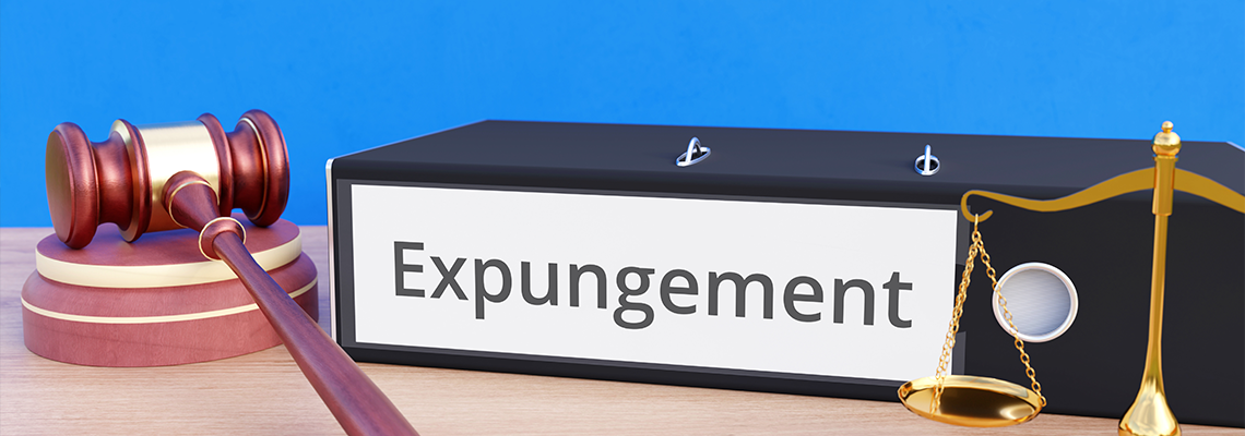 Gavel, scales of justice, and binder with the word Expungement along the side