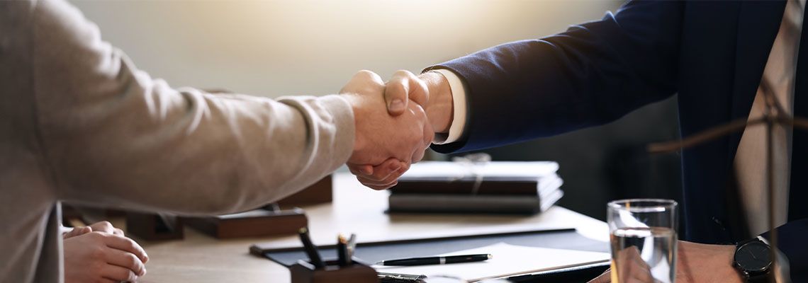 Male lawyer working with clients in office