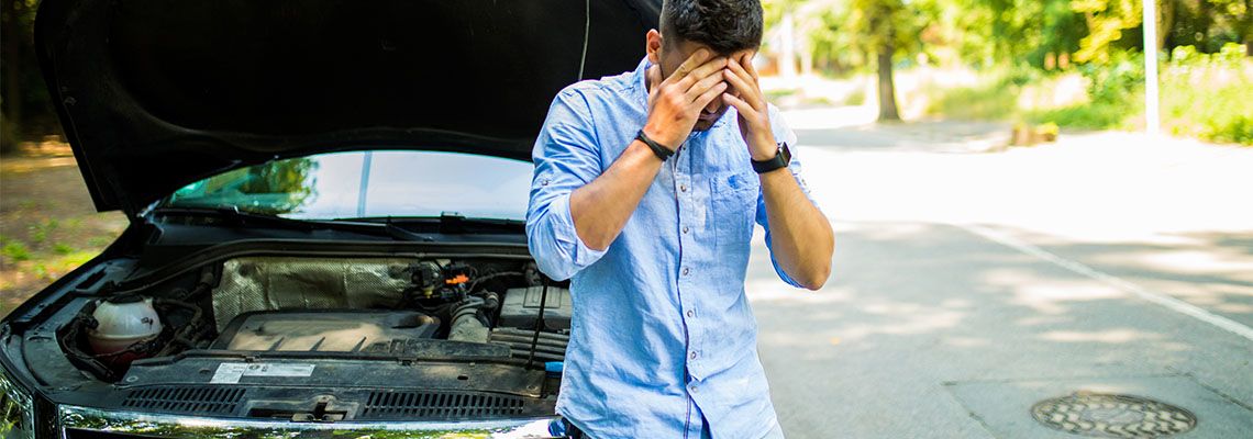 Young man on the road having problem with his car