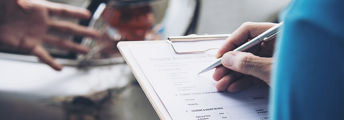 Insurance agent working during on site car accident claim process .