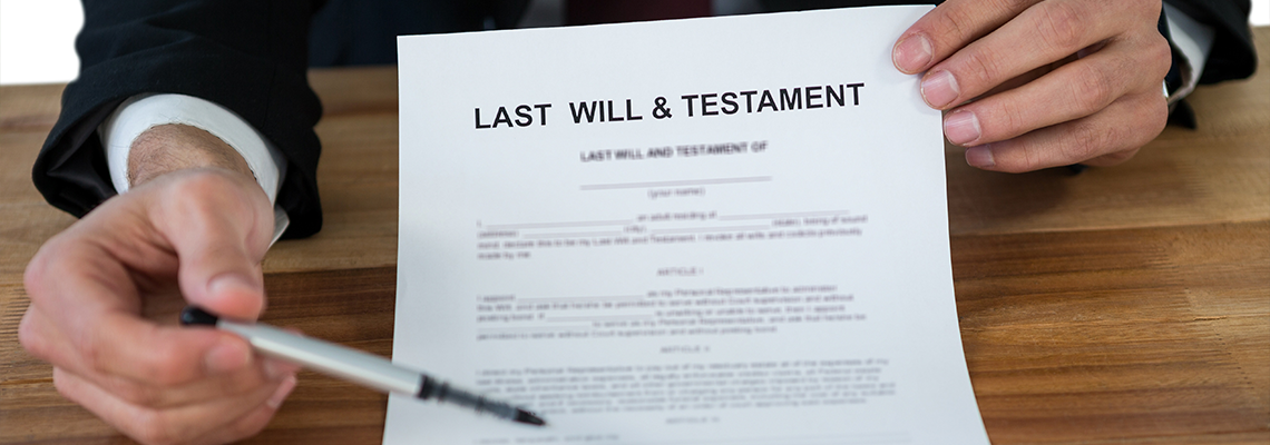 Mid section of businessman showing last will and testament form