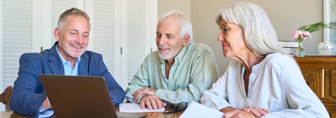 Senior couples consulting with professional for estate planningSenior couples consulting with professional for estate planning