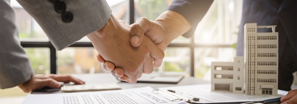Client and agent shaking hand after successful deal