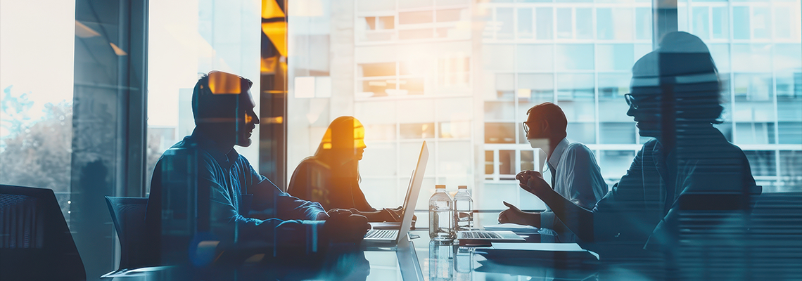 Double exposure of a business meeting focused on data analysis