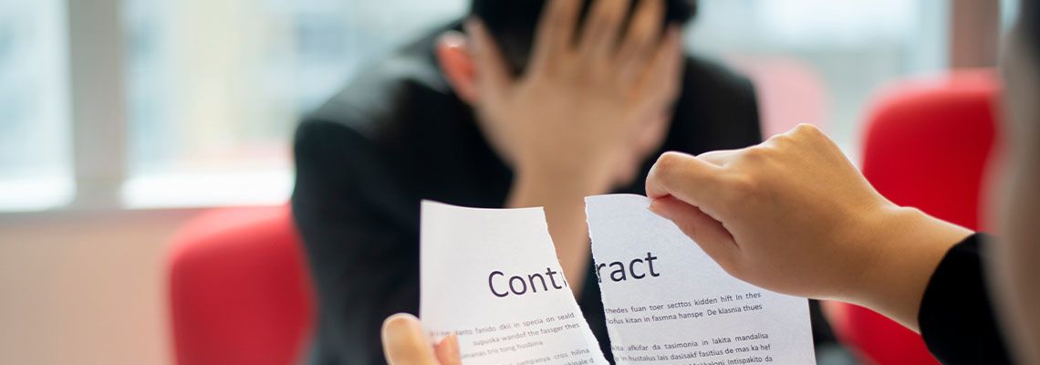 Businessman tearing contract agreement in office