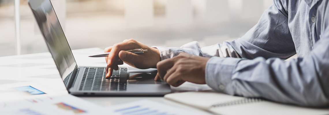 Modern business accountants are using laptops to check financial transactions