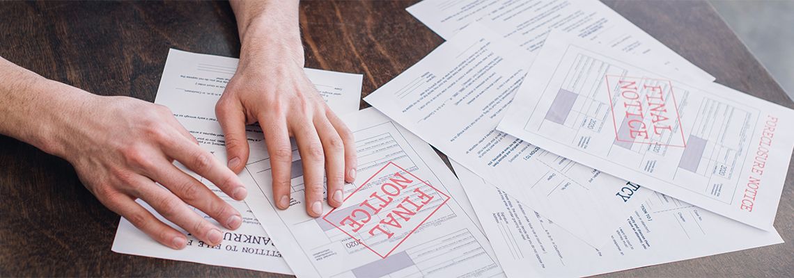 Male hands near foreclosure legal document