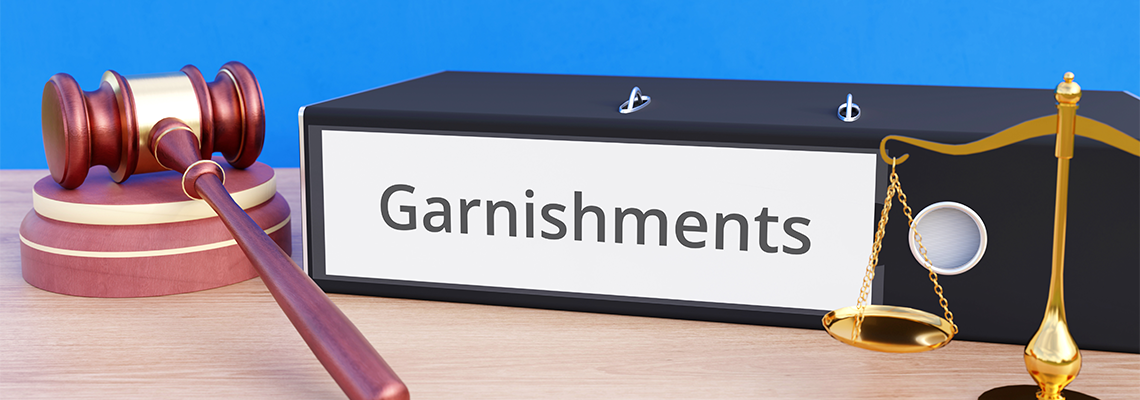 Garnishments – Folder with labeling, gavel and libra – law, judgement, lawyer