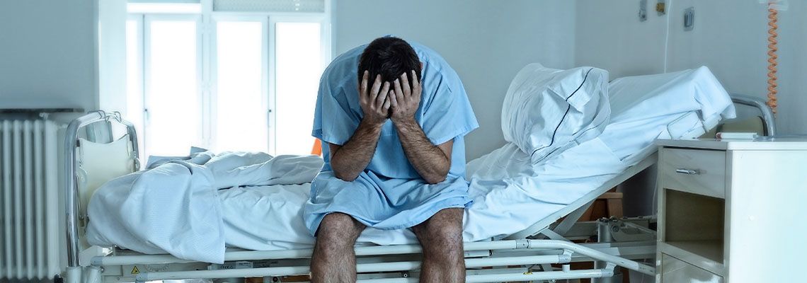 Sad man in hospital bed