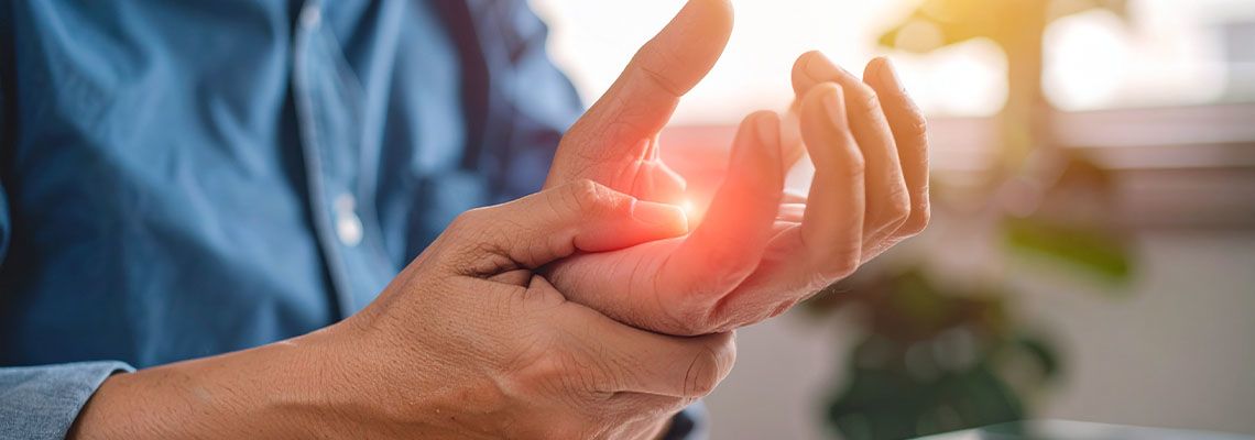 Man holding his hand in discomfort