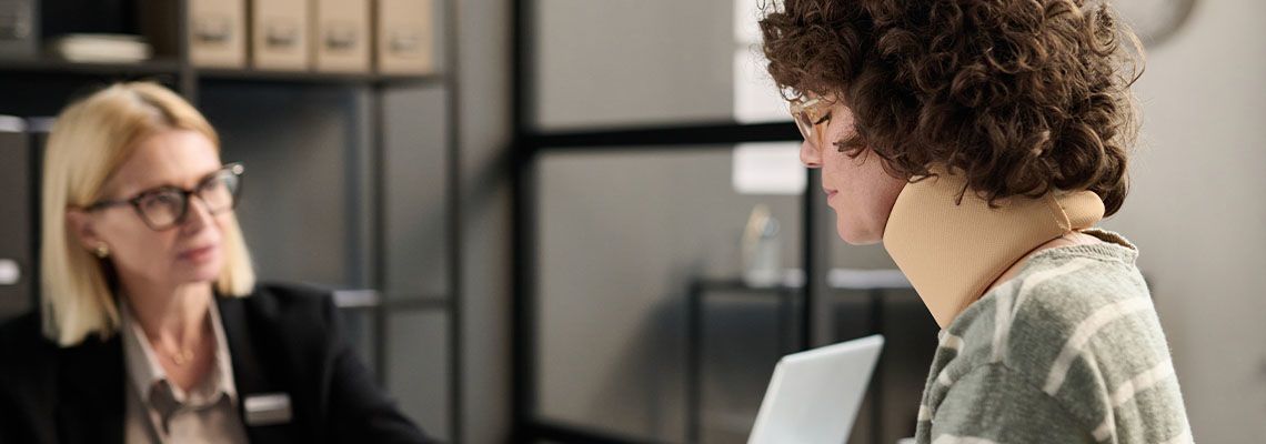 Women with neck injury consulting with attorney