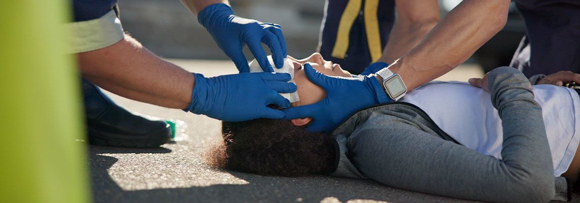 Paramedic helping women with head injury