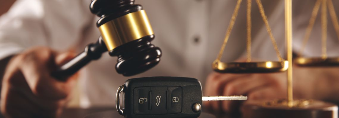 Gavel over car keys and scale of justice