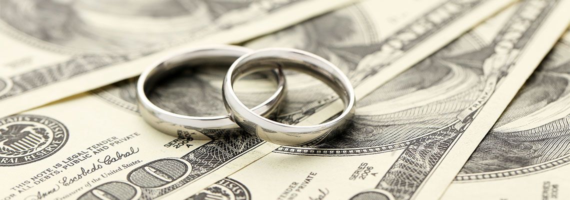 Wedding rings on one hundred dollars bill