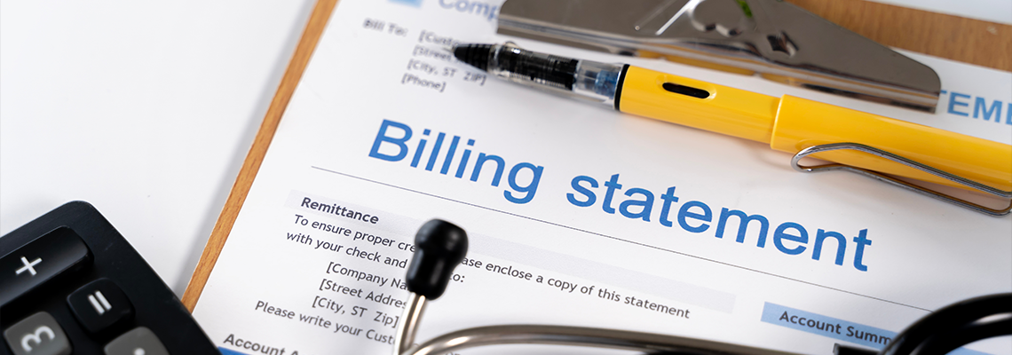 Medical Billing Statement with Calculator Pen and Stethoscope on Clipboard