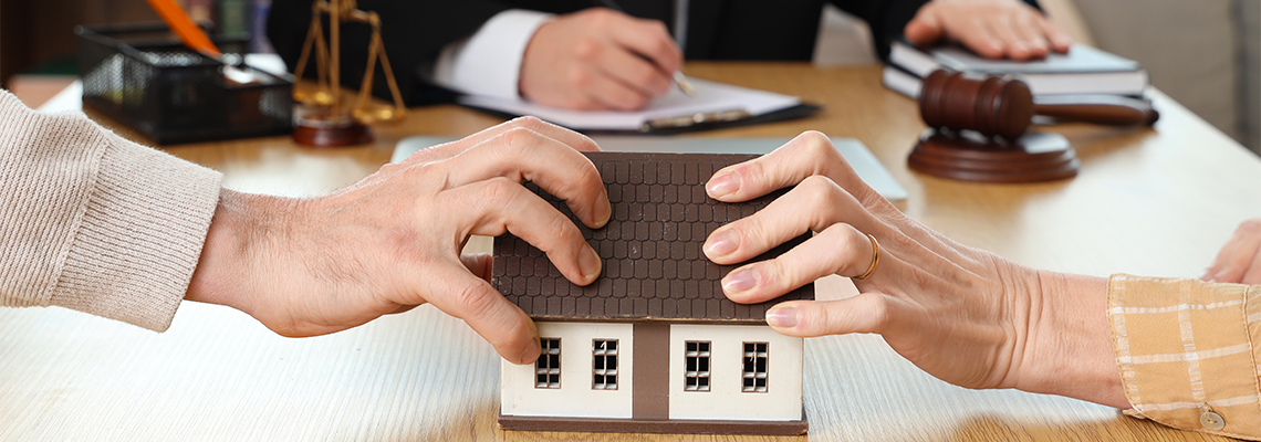 Mature couple dividing house at divorce lawyer's office
