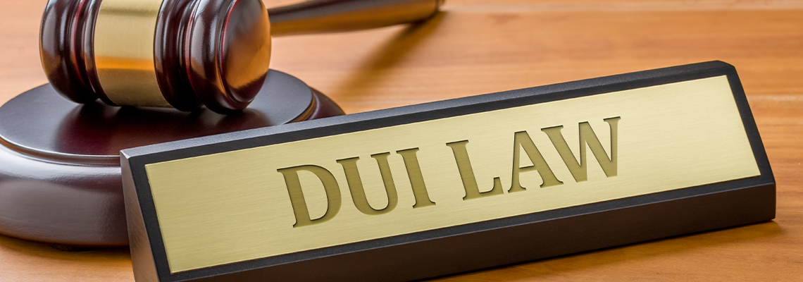 A gavel and a name plate with the engraving DUI Law
