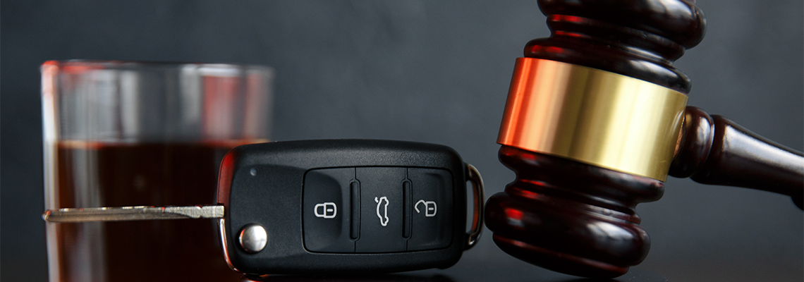 Law Hammer, Alcohol and Car Keys on Wooden Table