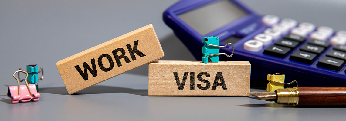 Focus on wooden blocks with letters making Work Visa text