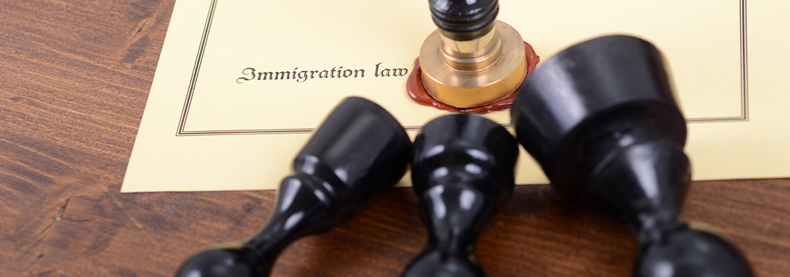 Notary seals and Immigration law on the wooden background