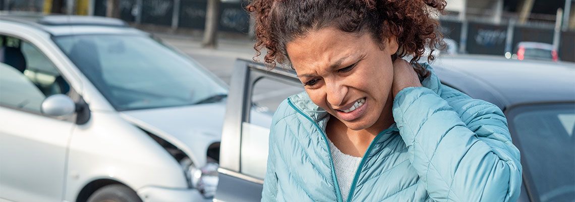 Woman suffering whiplash injury after bad cars accident